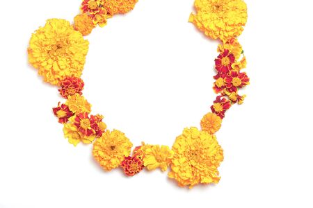 Wreath made of fresh orange, red flowers on white background. Fall concept. Flat lay, top view, copy spaceの写真素材