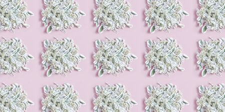 geometric floral pattern made of white, green leaves on pink background. fat lay, top view.の写真素材