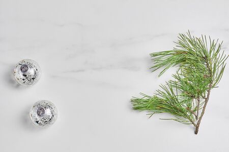 new year concept. green pine branch and Christmas decorations on marble background. flat lay, top view.の写真素材