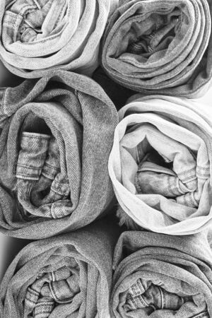 pattern of jeans rolled up in rolls. textured grey denim. vertical frame.の写真素材