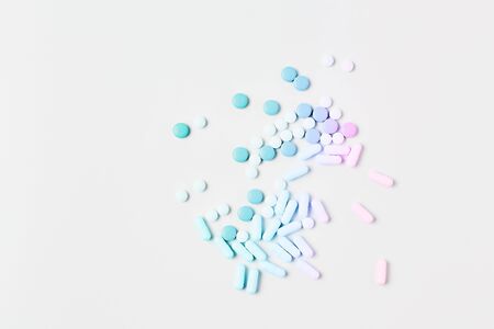 medicine concept. vitamins and pills to maintain healthy skin and hair. simple flat lay on a white background, space for text.の写真素材