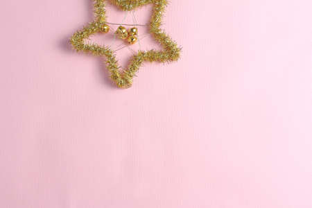 Christmas decoration in the form of a star on a pink background. Holiday concept, flat lay composition, top wievの写真素材