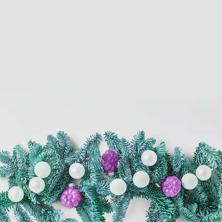 Christmas concept. Border of green fir twigs and balls decorative on white background. copy space, flat lay, square frameの写真素材