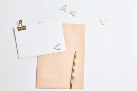 workplace concept. gold writing materials and notepad made kraft paper. mockup top view, simple flat lay compositions.の写真素材