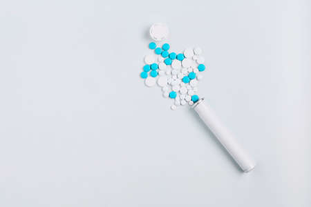 composition of an open container with pills on a white background. mockup medicine. top view, copy...