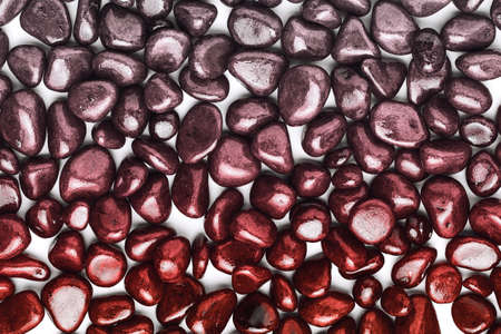 stones in the form of pebbles painted with a gradient from red to gray.