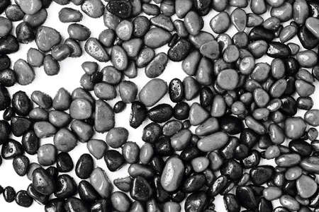 stones close up. pebbles of gray and black color in drops of water. view from above.の写真素材