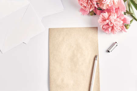 creative layout. office desk. home female workspace. a stack of envelopes and a notepad with a pen. flat lay, top view.の写真素材