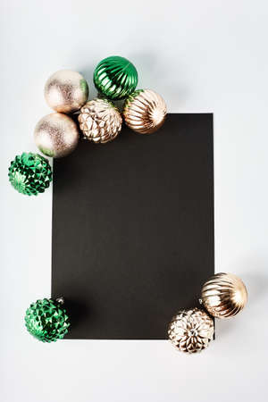 beautiful New Year mockup with black notebook and a frame of Christmas decorations on a white background. simple flat lay with place for text.の写真素材