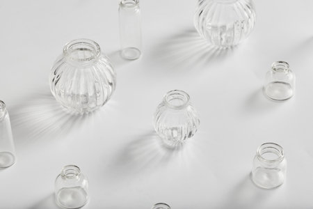 small transparent glass decorative vases for flowers on a white background. minimalist floral decor