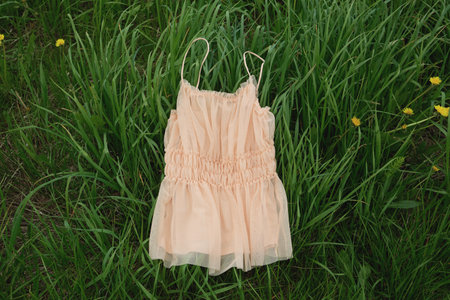 A lovely summer dress laid out on fresh green grass, perfect for a spring or summer holiday layout...