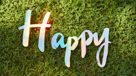 Panoramic summer banner. A vibrant display of the word Happy set against a lush green backdrop, perfect for holiday celebrations.の写真素材