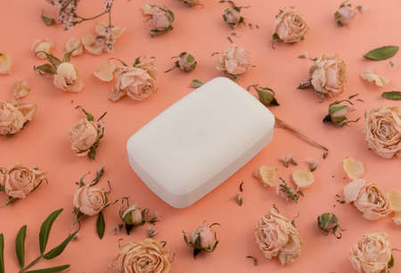 A bar of fragrant organic soap with dried flowers and rose leaves. The concept of hygiene and skin careの写真素材