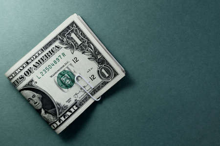Bundle of US one dollar banknotes close-up, isolated on grayish blue gradient background. Paper money of the United States of America. Copy space, color space. financial and economic concept.の写真素材