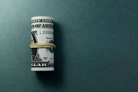Bundle of US one dollar banknotes close-up, isolated on grayish blue gradient background. Paper money of the United States of America. Copy space, color space. financial and economic concept.の写真素材