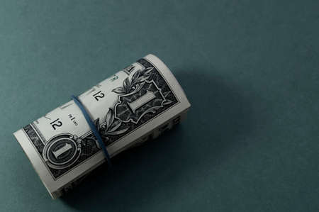 Bundle of US one dollar banknotes close-up, isolated on grayish blue gradient background. Paper money of the United States of America. Copy space, color space. financial and economic concept.の写真素材