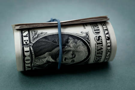 Bundle of US one dollar banknotes close-up, isolated on grayish blue gradient background. Paper money of the United States of America. Copy space, color space. financial and economic concept.の写真素材