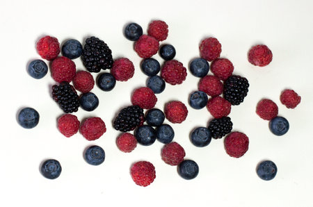 Ripe summer raspberry and blackberry isolated on white background.