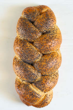 Homemade challah with poppy seeds. Traditional freshly baked jewish pastry.