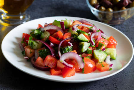 Salad with kalamata olives and olive oil on dark background close upの写真素材