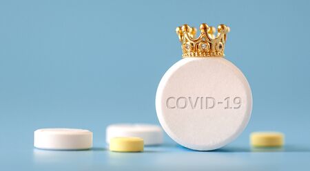 coronavirus COVID-19 macro foto. Dangerous virus. Medicine. Pills. Crown. Concept medicine. Health. Blue isolated backgroundの写真素材