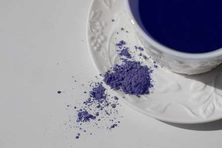 Blue matcha tea in a white cupの写真素材