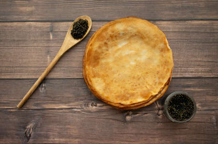 Pancakes and black caviar on the wooden background.の写真素材
