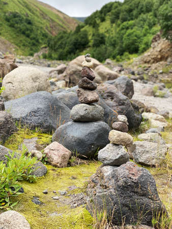 Pyramid of stones on the backdrop of mountains in the Elbrus region. Balance, meditation and stability concept.の写真素材