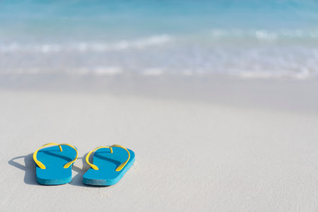 Flip flops on the beach on the background of the ocean in the Maldives. Beach holiday concept. copy spaceの写真素材