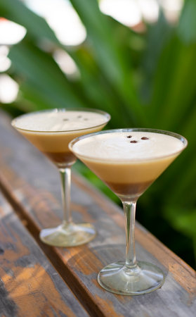Two glasses of espresso martini at a beach bar in the Maldives.