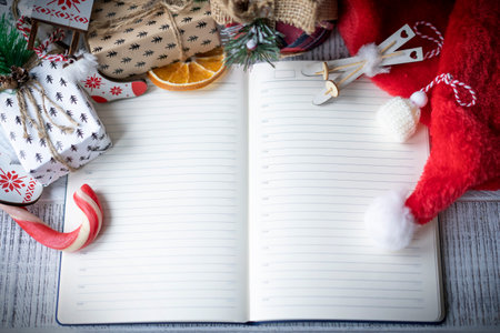 Opened notebook and Christmas decorations. Concept of new year's plans. Mockup, copyspace.の写真素材