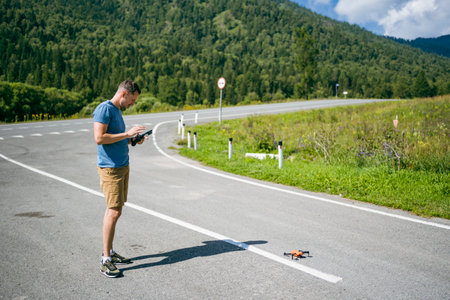 A young man launches a drone in the Chuysky Tract area. Altai Republic, Russia.