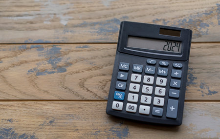 Calculator with the number 2024 on the display. Concept of finance, taxes, savings and economic crisisの写真素材