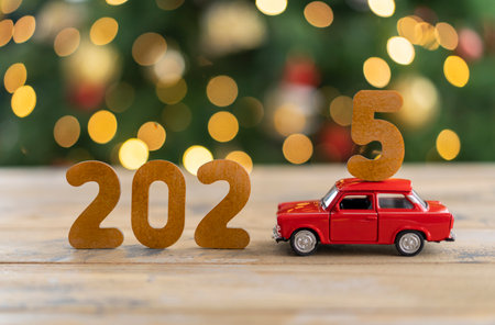 Wooden numbers 2025, toy car carries the number 5.