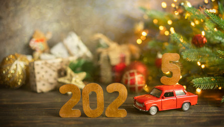 Wooden numbers 2025, toy car carries the number 5.