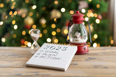 Notepad with the inscription - 2025 goal, plan, action on a wooden backgroundの写真素材