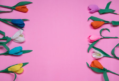 Frame for text with tulip flowers upper view on pink Valentines Day background. Spring banner. Happy women's day. Copyspace, flatlay.の写真素材