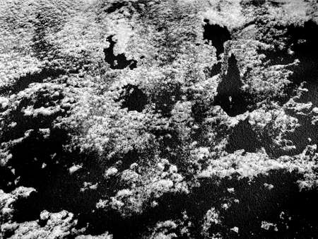 Snow pattern isolated on black background. White hoarfrost texture for designの写真素材