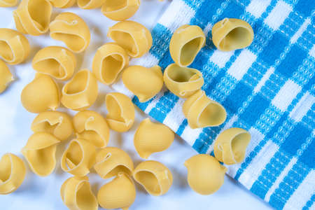 Raw pasta background, italian traditional macaroni on blue plaid cloth, wallpaperの写真素材