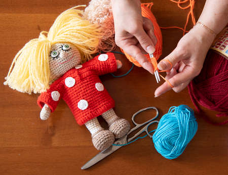 Female hands holding knitting needle. Woman knitting diy toys. Home activities during quarantine.の写真素材