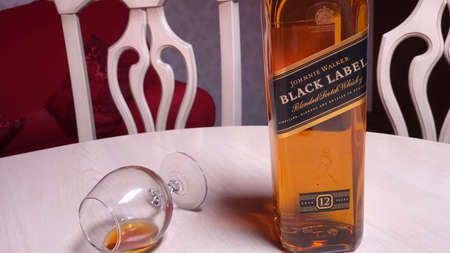 Bottle of Johnnie Walker Black Label Blended Scotch Whiskey on table in room. Perm, RUSSIA, 24 June 2021.のeditorial素材