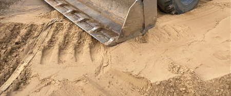 Bulldozer working on sand in the Construction Site. Wheel loader at work. Close up of hopper
