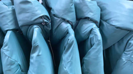 women blue coats, clothes on hangers in shop