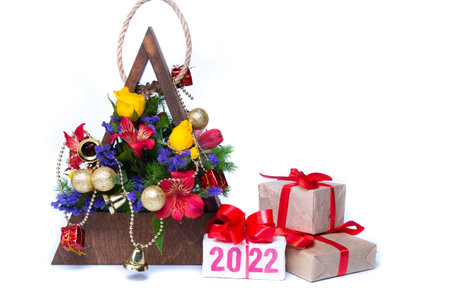 Christmas decorations and gift box with number 2022 on white background.