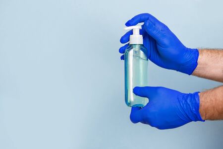Gloved hands pour liquid soap. Security from diseases and viruses.の写真素材