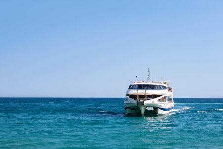 Beautiful white pleasure yacht at sea. Tourist ship in the ocean.の写真素材