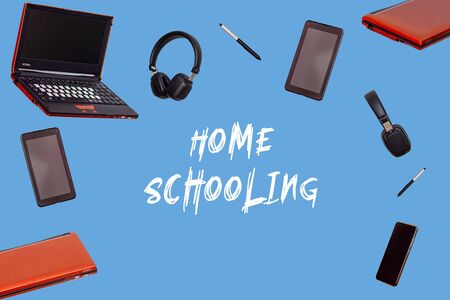 Online distance learning. Laptop, tablet, phone, headphones, stylus on a blue isolated background. Modern gadgets. home schoolの写真素材