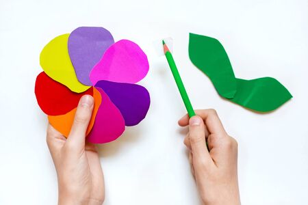 step by step instructions flower. How to make a flower at home from colored paper. Step 6. Glue a small piece of adhesive tape to the pencil, leaving free edges. Project for children DIY art.の写真素材