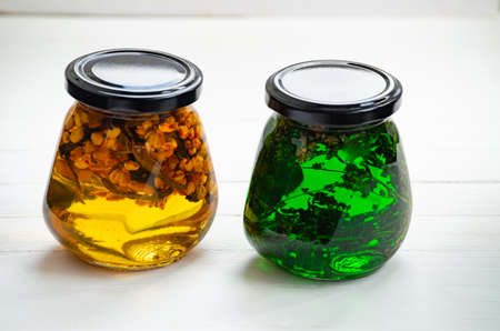 A glass jar with honey and herbs. Healthy eating and veganismの写真素材