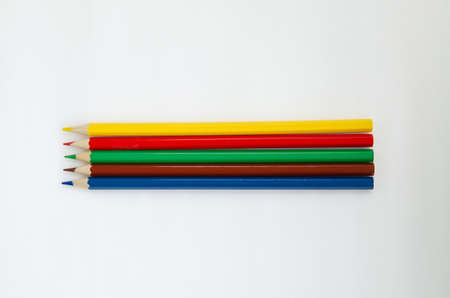 Sharpened colored pencils isolated on a white background. Office supplies
